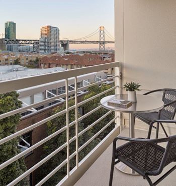 a balcony with a view of a city and a bridge